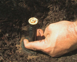 a Galena Park sprinkler repair pro is adjusting a sprinkler head