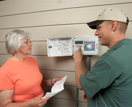 Jack, one of our West University Place sprinkler repair pros, is instructing the customer on her new timer